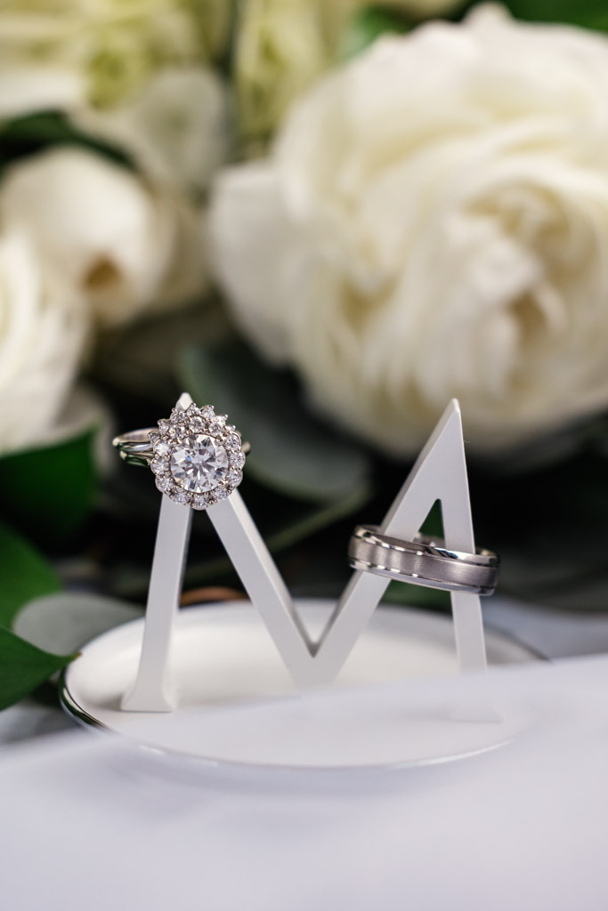 Two wedding rings rest on a white 