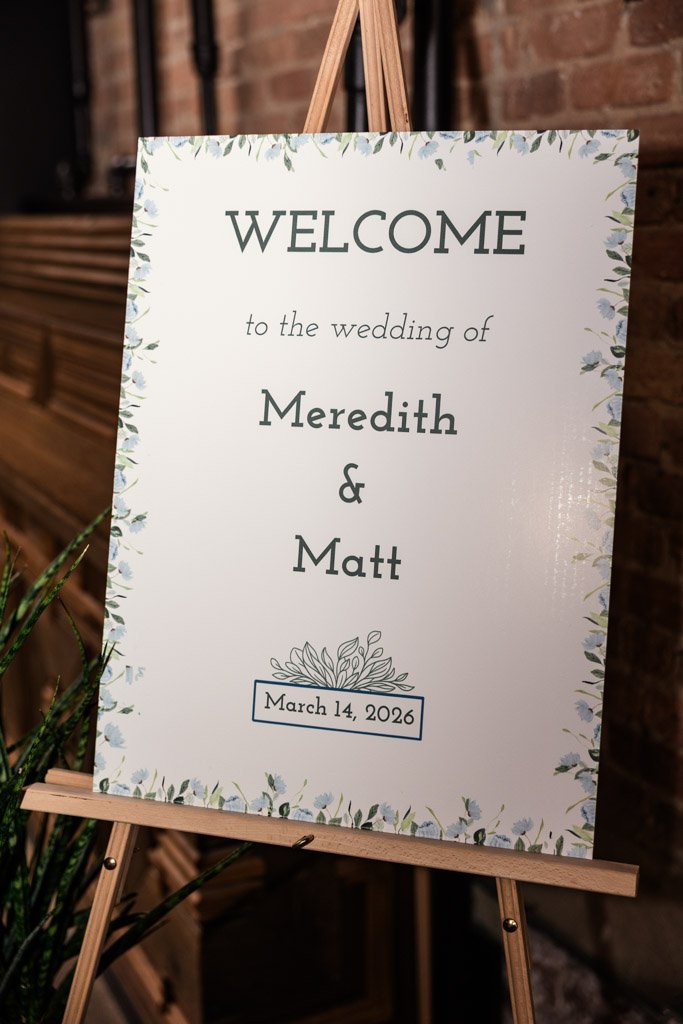 Wedding welcome sign on easel with floral border for wedding celebration at The Arbory