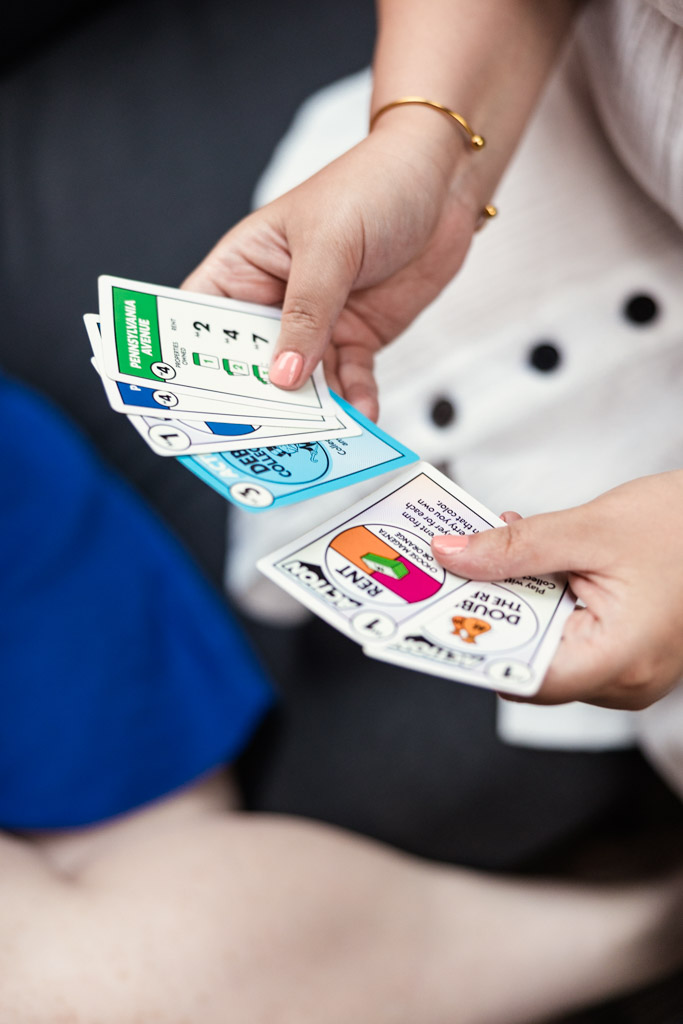 Detail ohoto of person holding Monopoly Deal playing cards during Wicker Park engagement session