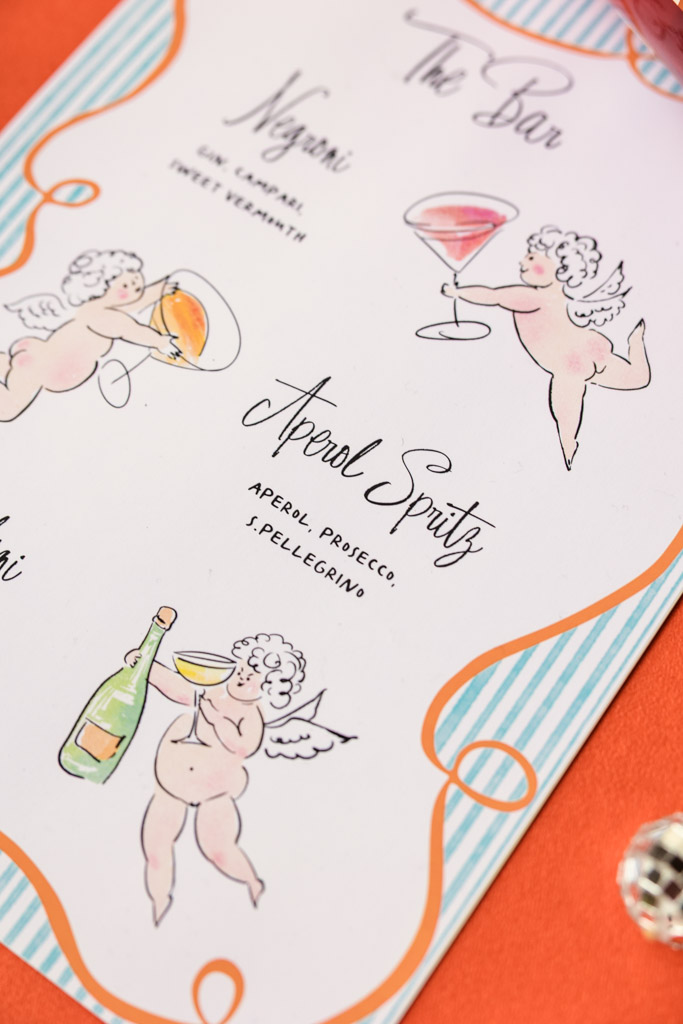 A menu for a wedding pool party with cherub illustrations holding drinks, listing cocktails like Negroni and Aperol Spritz on a striped border