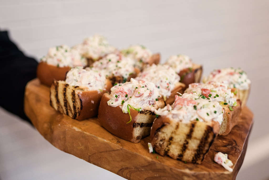 Appetizers served on a wooden board with grilled bread slices for wedding celebration at the University Club of Chicago