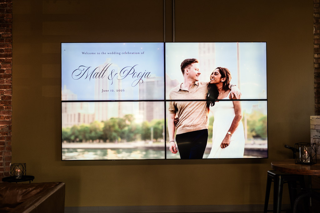 Sangeet welcome message displayed on four screens with image from couple’s engagement session